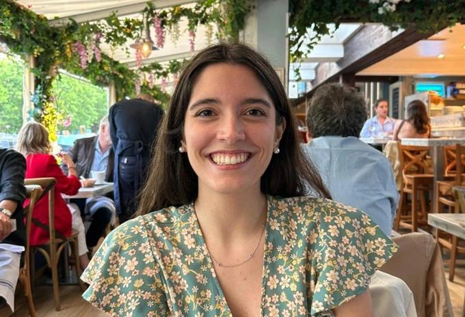 Arianna Magnanini smiling and sitting at a restaurant table