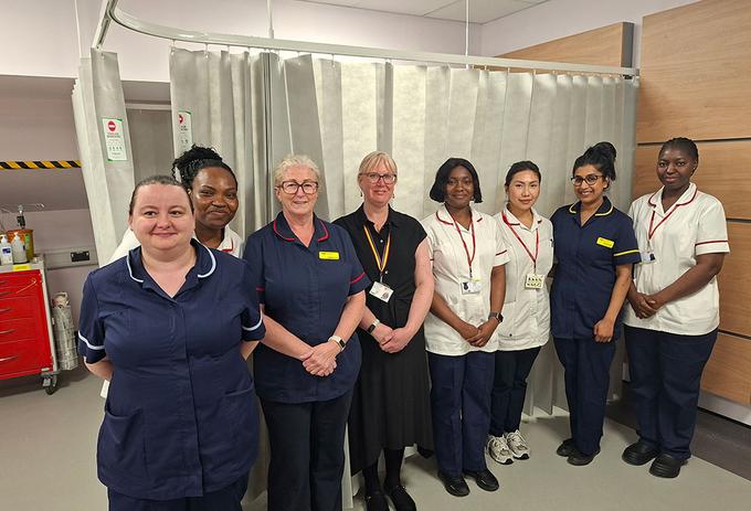 Nurses look towards the camera in a hospital
