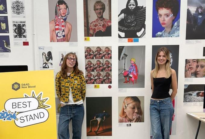 Two students show a display of student artwork