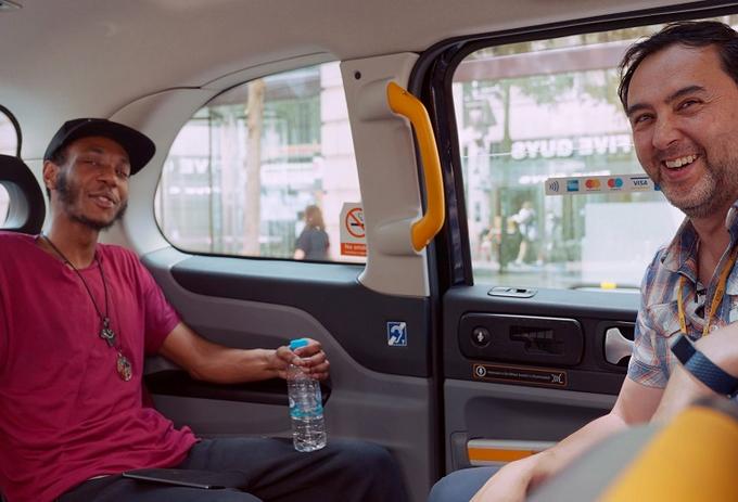2 people posing in a cab