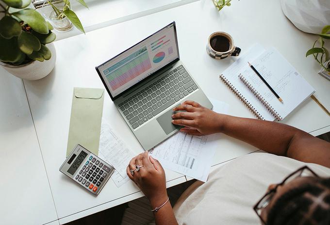 Person sat on desk on laptop