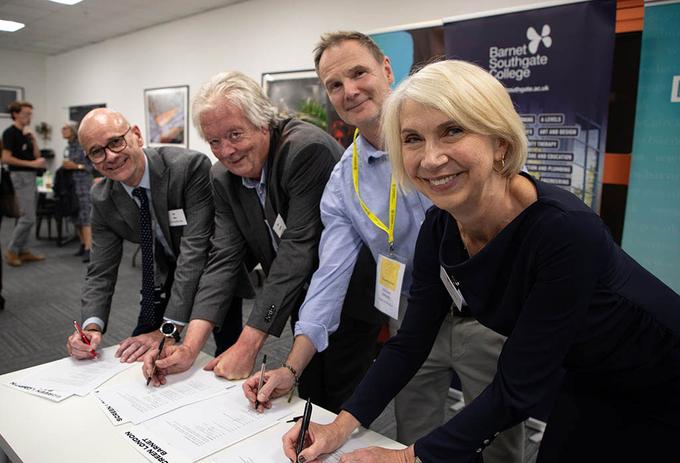 People sign paper in a studios