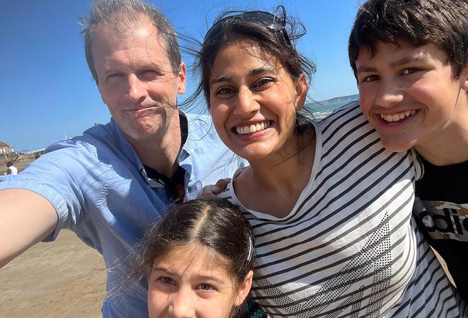 A family smile for the camera on the beach