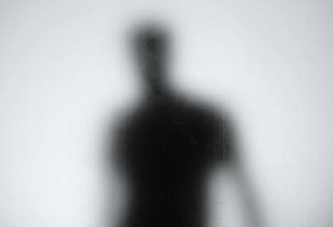 A blurry silhouette standing in the distance