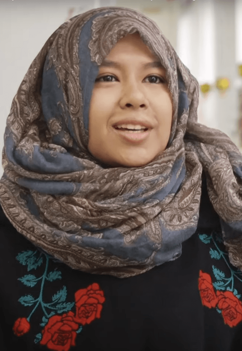 young woman from Malaysia wearing a head scarf smiling