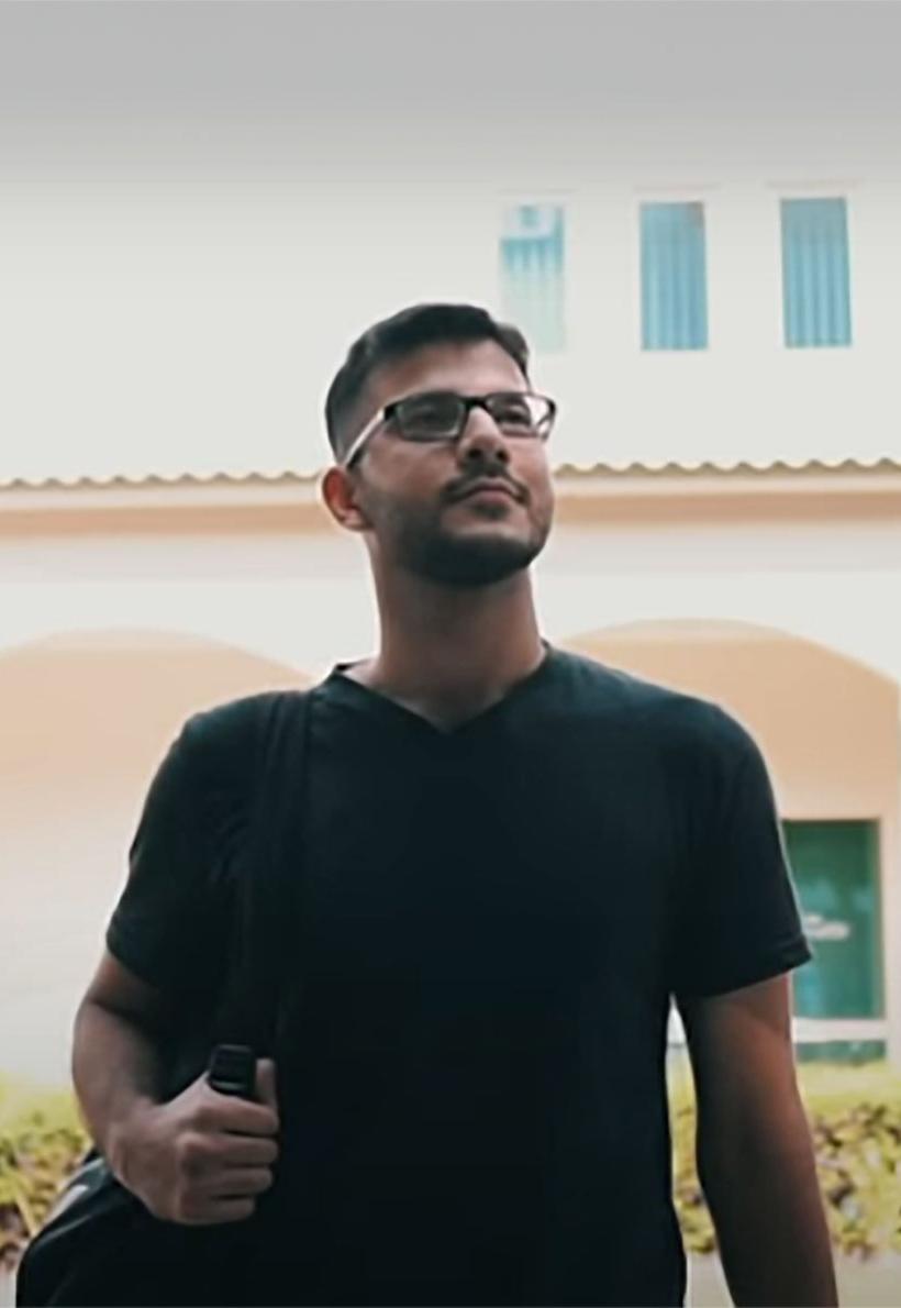 a male student stands in front of dubai university