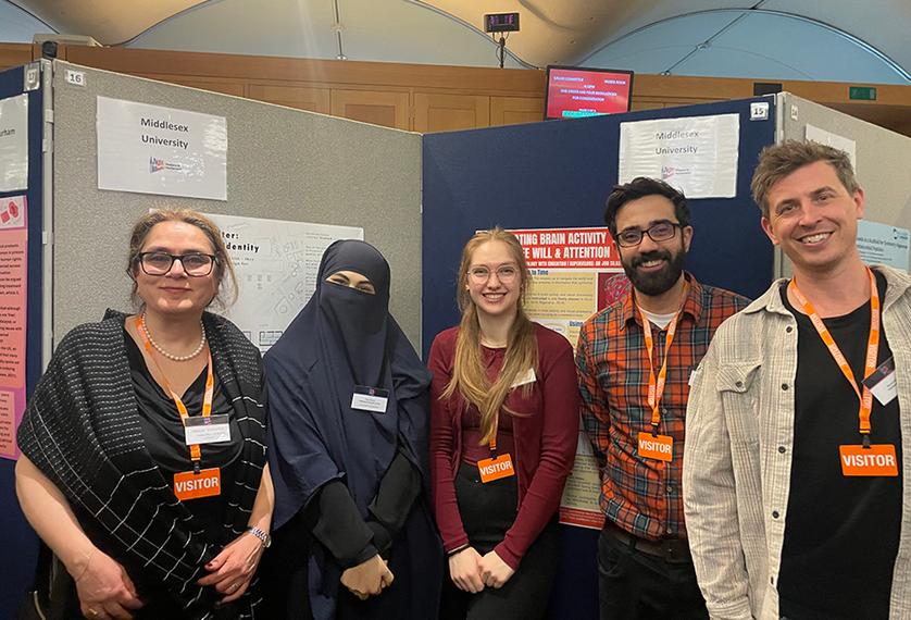 Five people standing and smiling at the camera