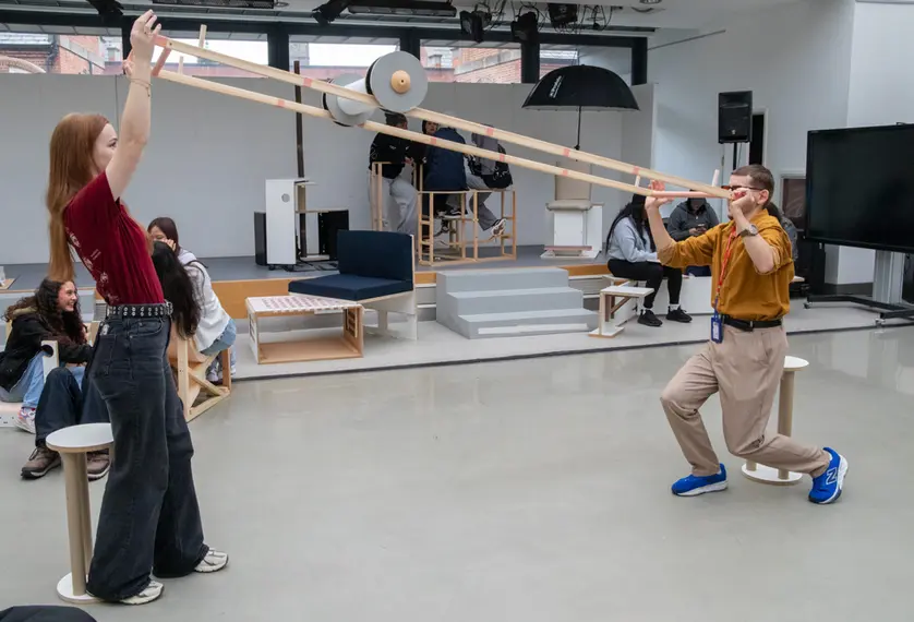 Two people interact with a roller in a studio