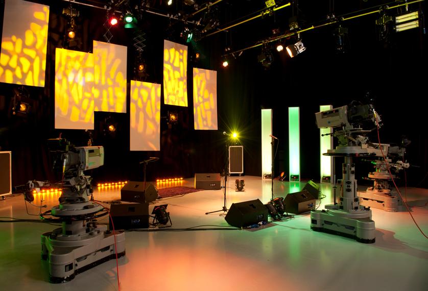 a TV studio with two large cameras and a studio backdrop