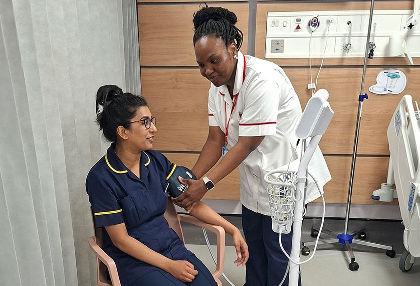 Student nurse performs a blood pressure check