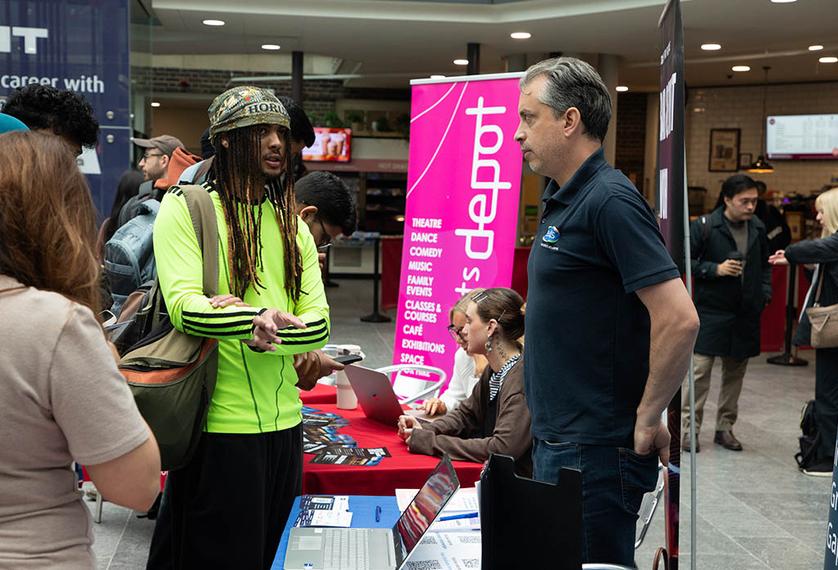 Students speaks with employer at university event