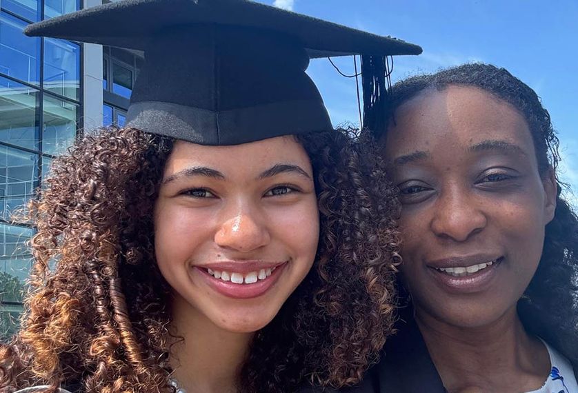 A student graduate poses for photo