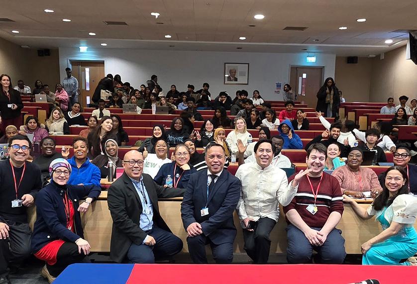 People look at the camera in a lecture theatre