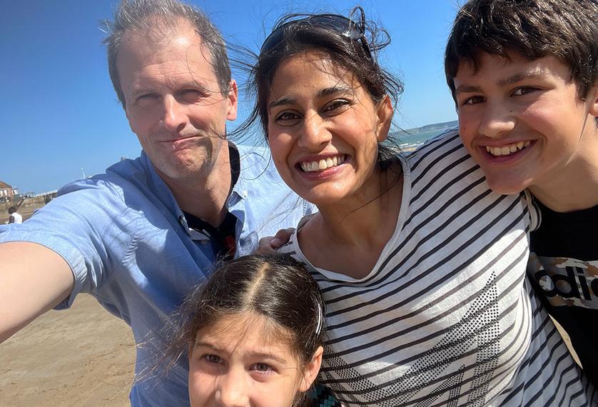 A family smile for the camera on the beach