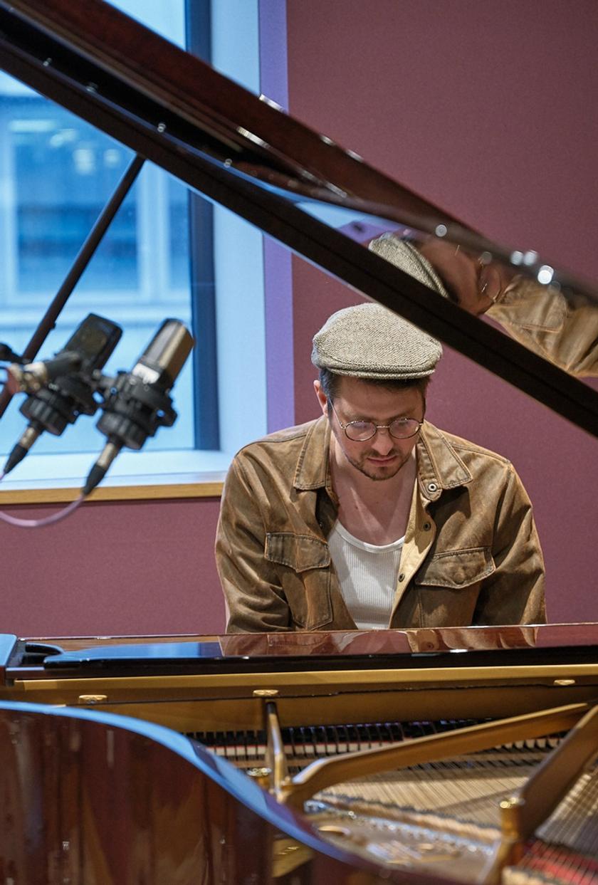 Music production set up alongside speakers and headphones