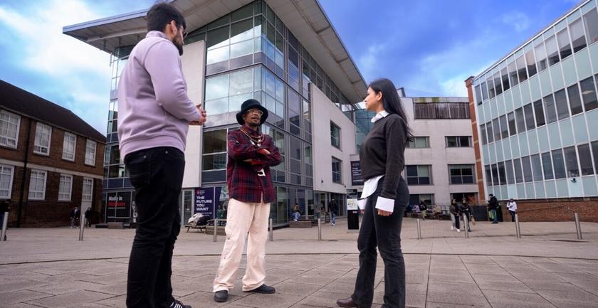 Students standing between buildings