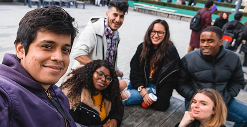 Group of students sat together on campus
