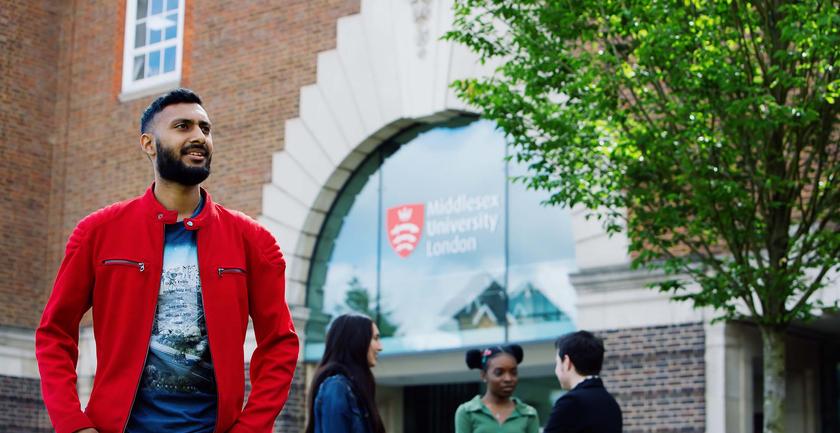 Male student outside stood outside main Hendon campus building