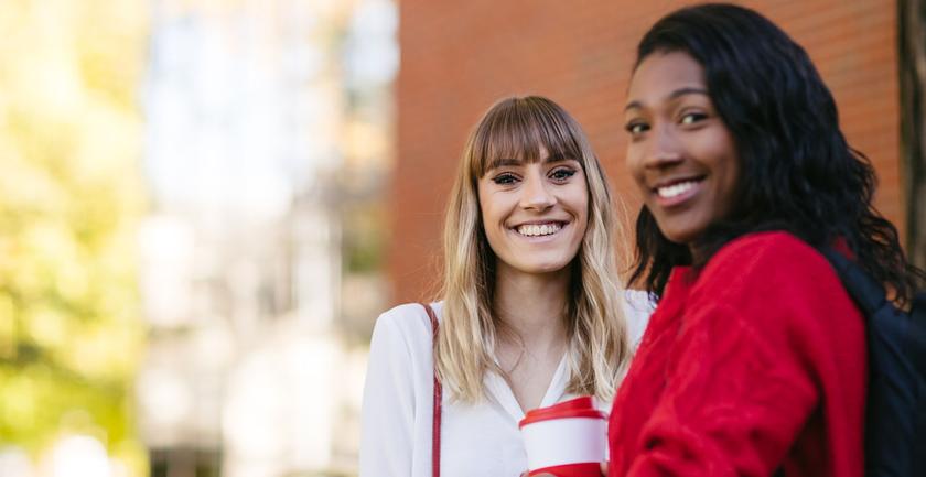 two students smiling on campus