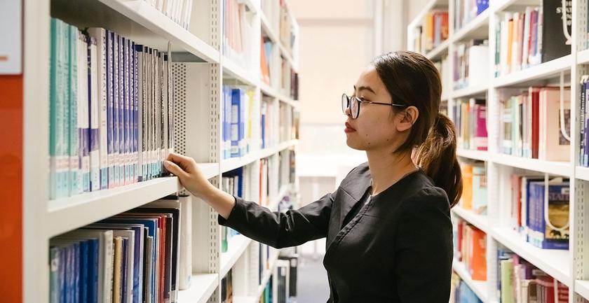 student browsing books in library