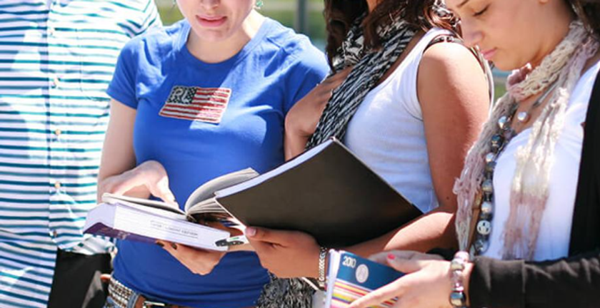 Four students reading from books