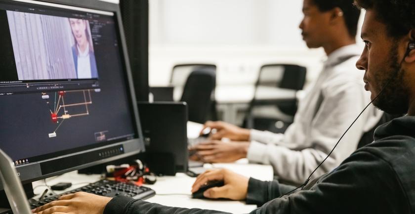 A student designing a game on the computer