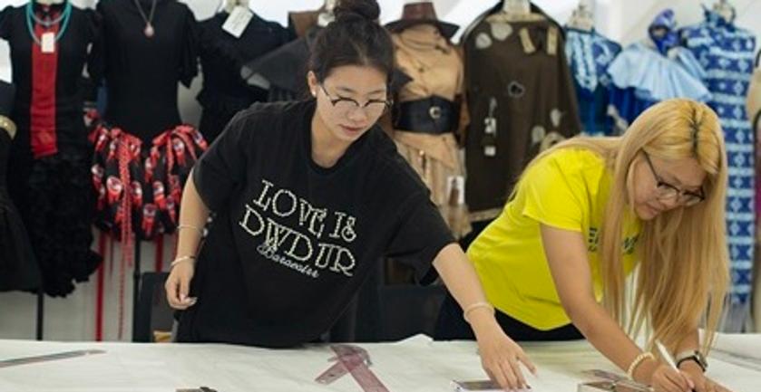 A group of fashion students working in a textiles workshop
