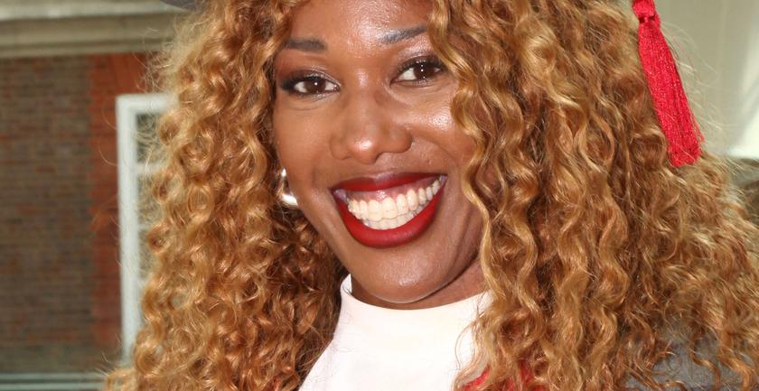 Montell Douglas smiling at the camera and wearing an Honorary Doctor's academic robe