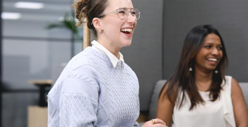A member of staff laughing with colleagues