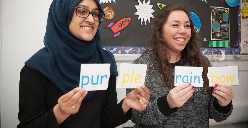 Two women holding up signs