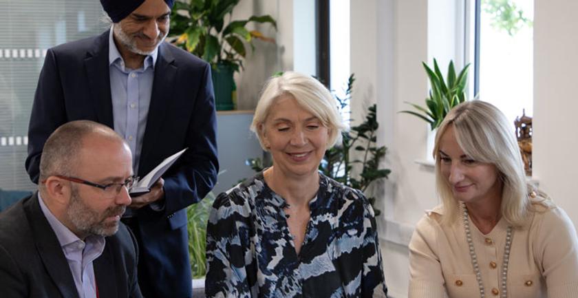 VC of middlesex university in a conversation with other executive colleagues