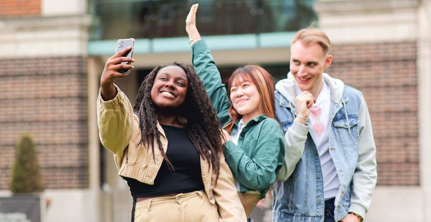Three students on campus taking a selfie