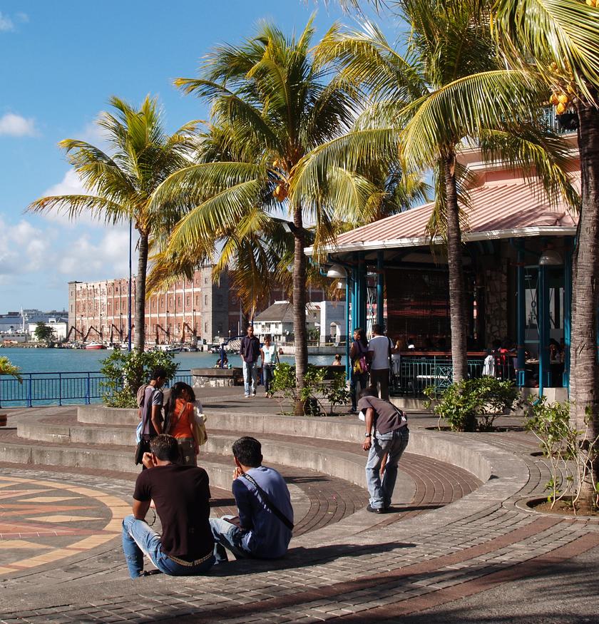 Seaside in Mauritius with huts and palm trees