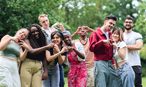 A diverse group of smiling students in Grove Park