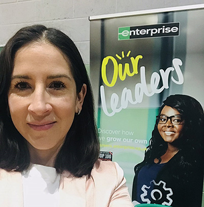 Woman posing with banner for