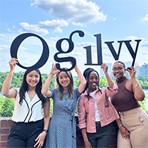 People holding the Ogilvy sign