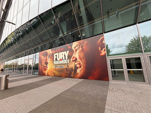 A poster made by Raiyaan Omar, for the match between Fury and Makhmudov, on the outside of a stadium.