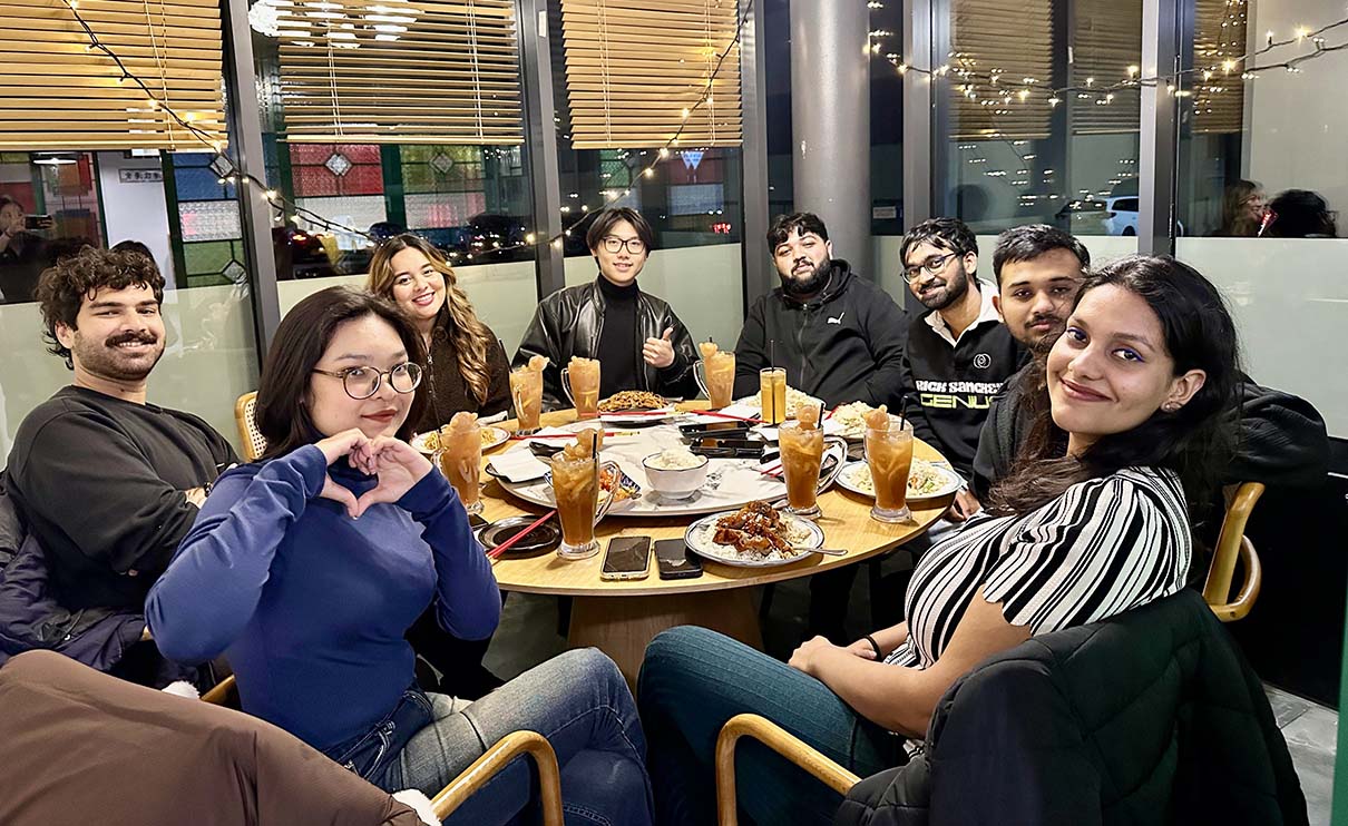 Students sat at restaurant table on Sheffield marketing trip