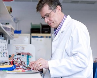 Professor Bayford wearing a lab coat, working in a lab