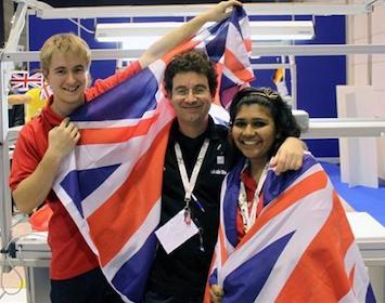 Group of three people holding up a Union Jack flag.