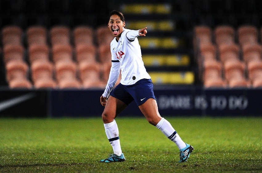 Female soccer players on the field.