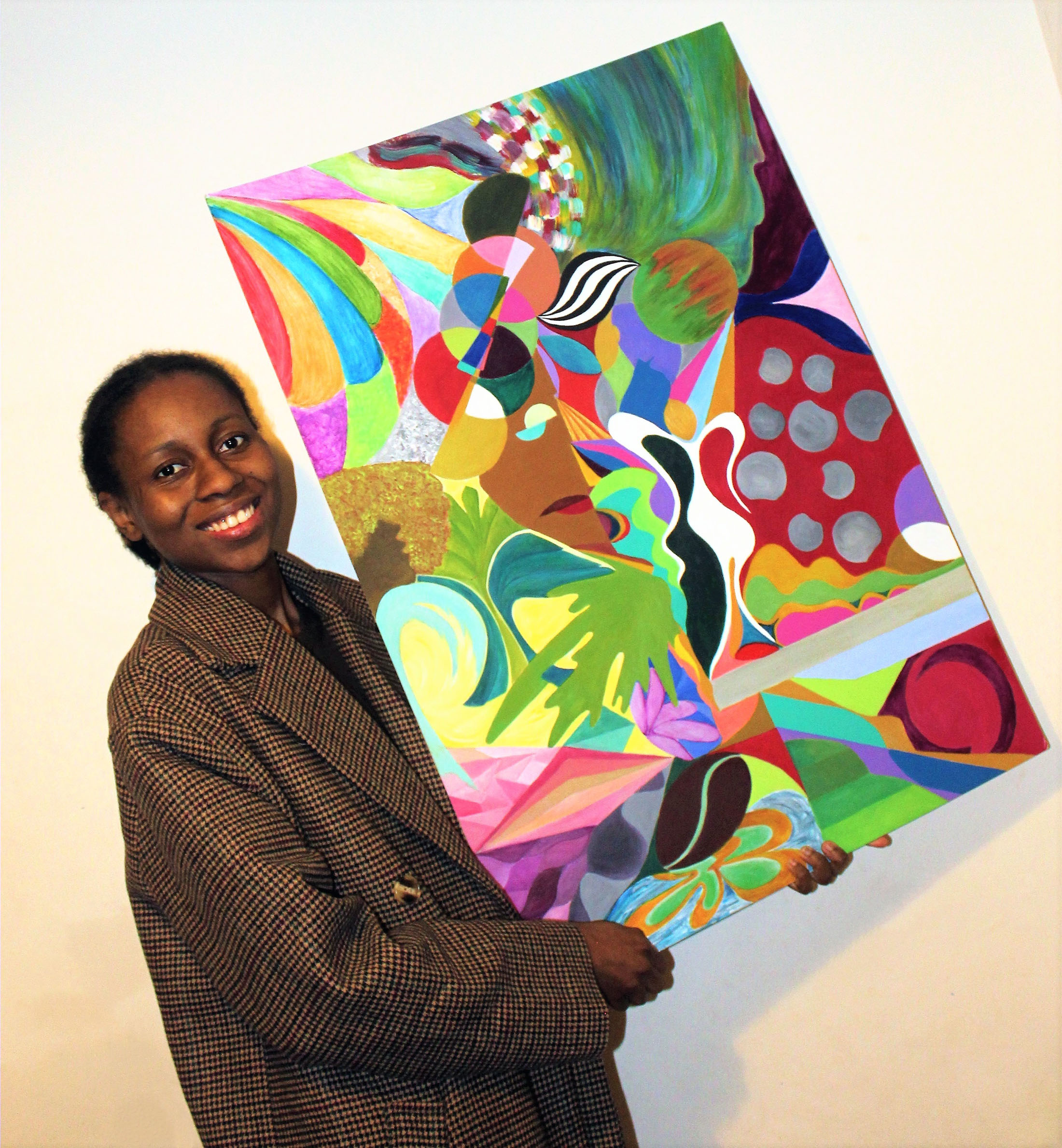 Madina Aw Tall with brightly coloured abstract canvas with face