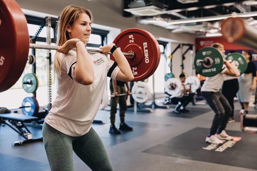 A girl is lifting weight in West Stand gym