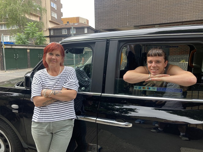 2 People posing with a Cab