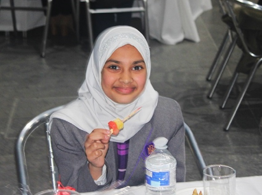 A little girl having iftar at MDX quad