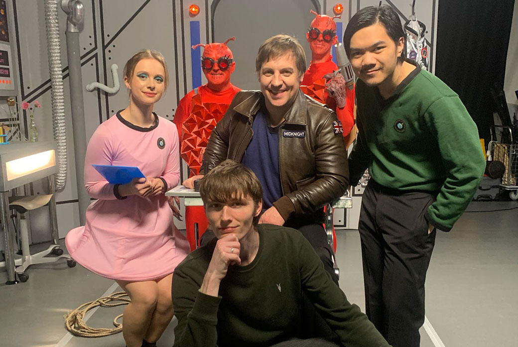 Cast from a play pose for camera