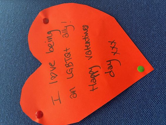 A red paper Valentine's heart with a message reading: