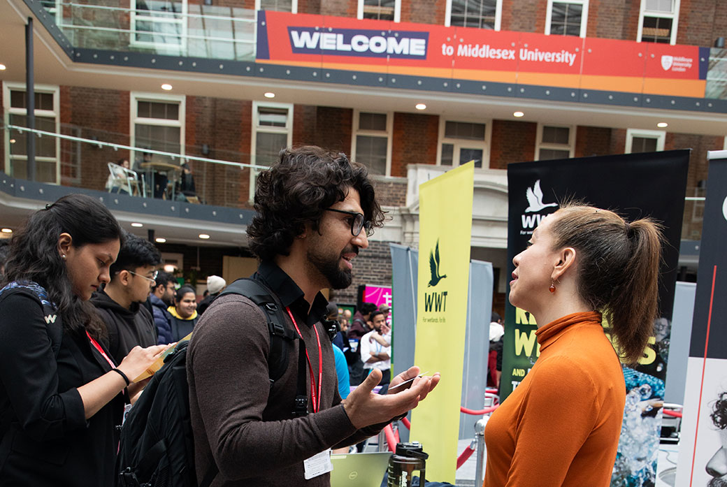 Student speaks with employer
