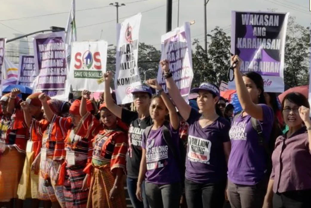 Womens' rights protestors hold up signs