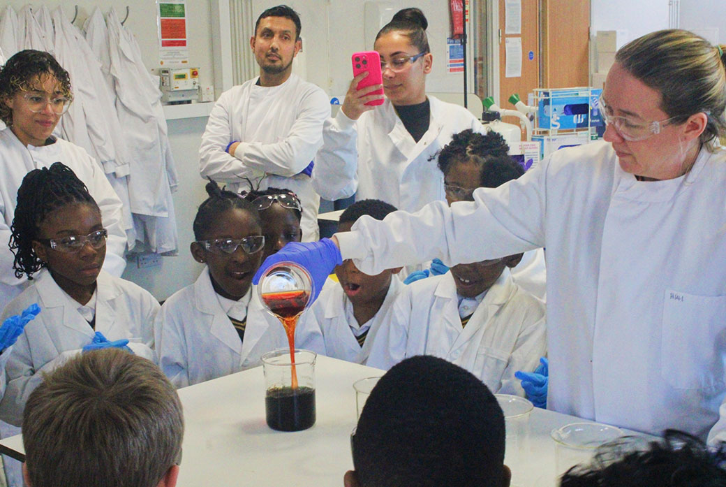 School pupils watch chemistry experiment